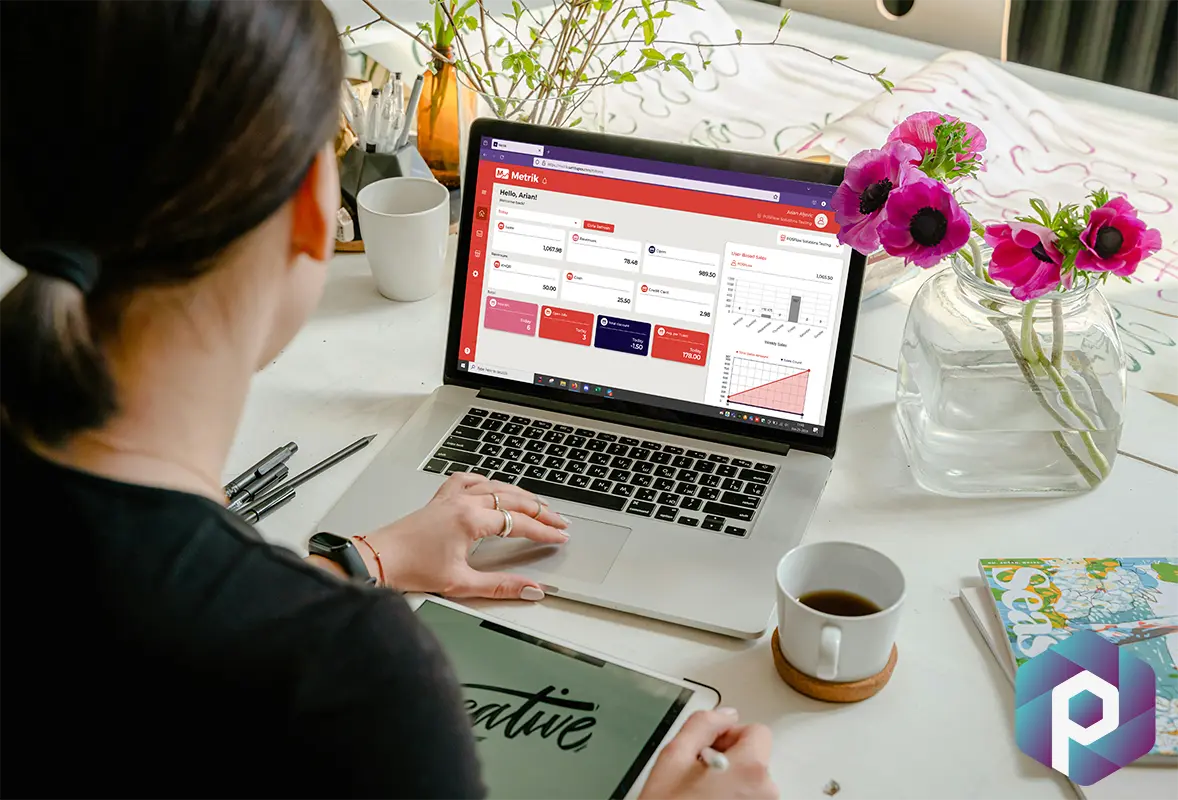Laptop with Metrik reporting app showing
